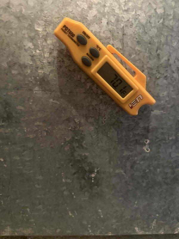 Completed cooling check on one air conditioning system as part of scheduled maintenance agreement. Inspected evaporator coil and found significant discoloration, staining, and accumulated dirt buildup between fins, indicating need for future cleaning to maintain optimal heat transfer efficiency. Performed diagnostic temperature measurements using infrared thermometer to verify system operation and cooling performance.
