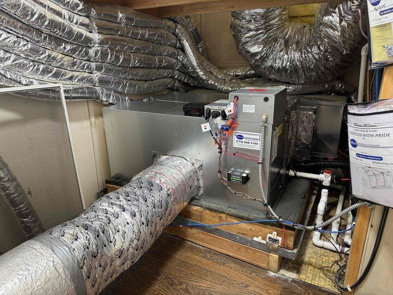 Completed full HVAC system replacement including outdoor condensing unit, Unico air handler, and evaporator coil. Installed new air handler in attic space with proper mounting and leveling on existing floor joists. Connected multiple insulated flex duct runs to air handler for distribution throughout the home. Established condensate drain line with PVC piping and verified proper drainage. Completed all electrical connections including power supply and control wiring between components. Verified system operation with digital thermometer readings showing proper air temperature at 71.9°F. All equipment secured, labeled, and tested for optimal performance.