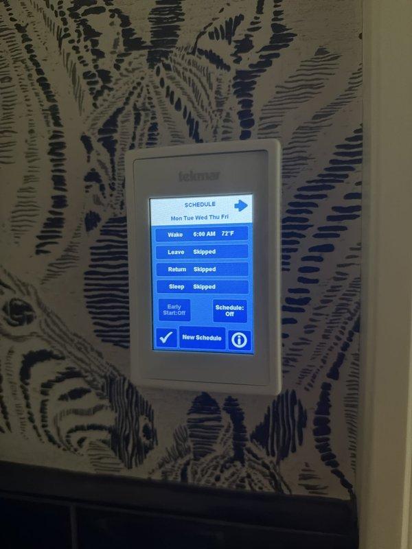 Responded to service call for non-operational radiant heating system. Upon inspection, found low system pressure as indicated by the boiler pressure gauge reading below operational threshold. Verified thermostat programming showing active heating schedule set for 77°F at 6:30 AM wake period. Inspected boiler feed water assembly including pressure gauge, isolation valves, and braided supply line connections. Restored proper system pressure through the fill valve to bring boiler pressure into normal operating range. Verified all isolation valves in correct positions and confirmed no visible leaks at connections. System tested and confirmed radiant heat restored to normal operation with proper pressure maintained.