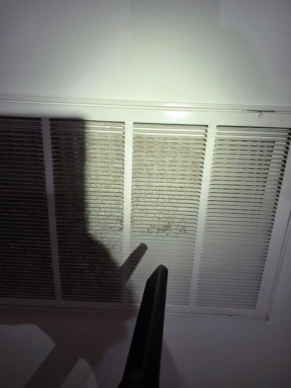 Replaced condenser unit under warranty coverage. Upon completion, inspected air return vents and documented existing dust accumulation on grille louvers for homeowner awareness. System operational and functioning within manufacturer specifications.