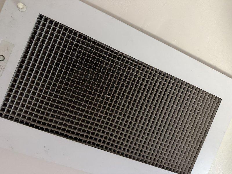 Responded to callback for newly installed AC unit not cooling properly. Upon inspection, verified return air grille installation and traced ductwork and condensate drain lines in attic space. Examined PVC condensate piping connections and flexible ductwork routing between joists. System components appeared properly installed with adequate insulation coverage around ductwork. Identified and resolved cooling issue, confirmed unit operating to manufacturer specifications before departure.