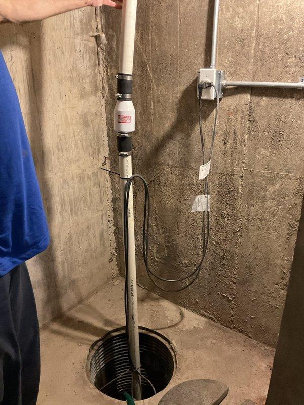 Completed comprehensive three-level plumbing inspection of residential property including basement, two full bathrooms, and one half bathroom. Thoroughly examined sump pump system in basement utility area, documenting vertical discharge pipe assembly with PVC sections and black couplings, verifying proper installation of float switch mechanism and electrical connections. Observed existing rust staining on pipe joints and fittings, noting age-related surface wear on plumbing components. Inspected auxiliary utility piping, electrical junction boxes, and associated wiring runs along basement walls. Photographic documentation captured for all critical plumbing fixtures and mechanical systems throughout all levels of the residence.