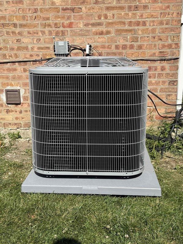 Completed full HVAC system replacement including furnace, evaporator coil, humidifier, and air conditioning condenser unit. Removed existing equipment and installed new furnace with matching evaporator coil in indoor air handler location. Integrated whole-home humidifier into ductwork for enhanced comfort control. Replaced outdoor AC condensing unit on existing concrete pad, connecting refrigerant lines and electrical service. Verified proper system operation using dual port manometer to measure gas pressure readings at 148 and 140 units on ports P1 and P2 respectively. All components tested and confirmed operational. Two-technician installation completed in single day. System commissioned and ready for service.