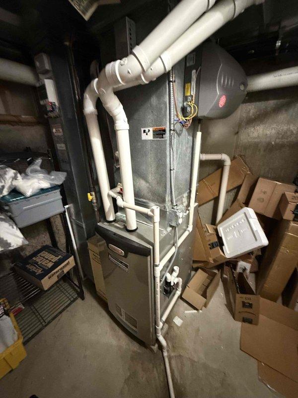 # HVAC Service Call - No Cooling Issue

Responded to service call for dual air conditioning system with one unit failing to produce adequate cooling. Customer reported unit only delivering cool air rather than cold air. Both systems are 15-20 years old.

## Diagnostic Findings

Performed comprehensive system evaluation on the affected unit. Utilized digital temperature measurement equipment to assess air temperature differential across the evaporator coil, recording supply air temperature of 54.8°F. Inspected indoor air handler and plenum assembly for proper airflow and component operation.

Conducted visual inspection of air filtration system, noting moderate dust accumulation on pleated filter media. Filter appeared to be restricting airflow, which can reduce system efficiency and cooling capacity. Examined metal ductwork and housing components, observing significant aging with dust and grime buildup throughout the system.

Assessed furnace/air handler unit configuration, including P