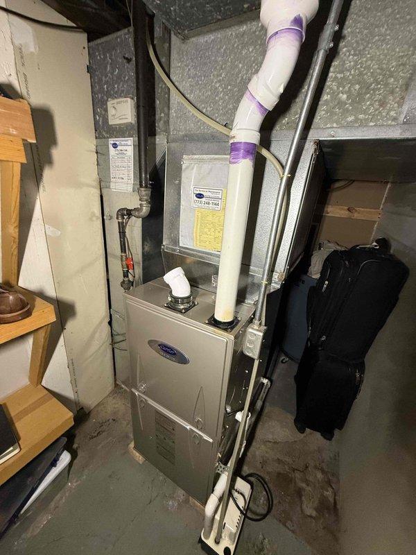 Completed comprehensive air conditioning maintenance agreement inspection on Carrier HVAC system. Performed full checklist including condenser coil inspection for cleanliness and leaks, blower motor and wheel debris check, indoor relative humidity testing, refrigerant level measurement, and cycling of operating controls. Inspected line voltage switch and wiring for safety compliance, verified condensate system drainage, checked all electrical connections for tightness and deterioration, and examined refrigerant lines for visible leaks and insulation condition. System found operating in cooling mode with thermostat set to 70°F and current temperature at 74°F. All components functioning within normal parameters with no immediate concerns identified.