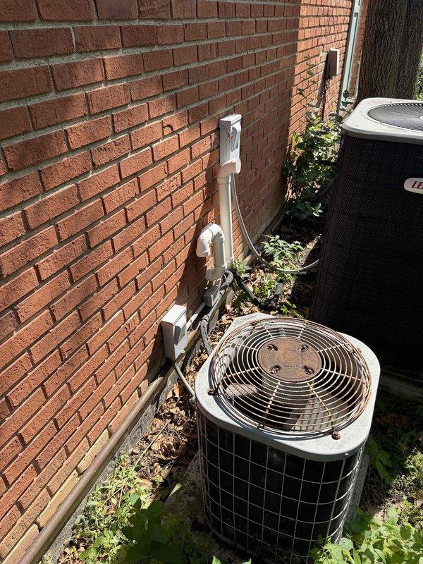 Evaluated 29-year-old R22 air conditioning system serving home addition and found multiple failed components beyond economical repair. System utilizes phased-out R22 refrigerant, making future service increasingly difficult and costly. Documented existing indoor humidifier installation integrated with ductwork in mechanical room and outdoor condensing unit positioned alongside building foundation. Provided comprehensive replacement recommendations for complete system upgrade to modern, efficient equipment compatible with current refrigerant standards.