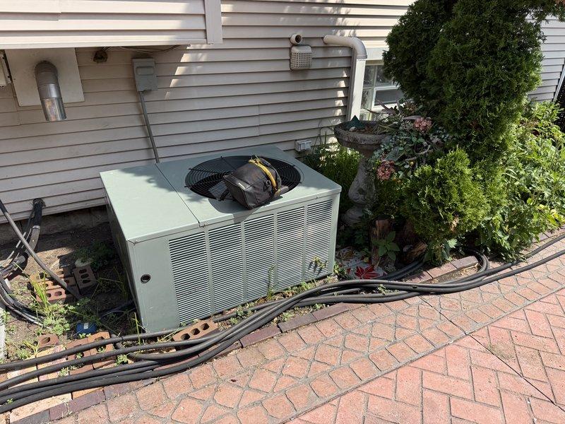 Responded to no-cooling call on Rheem Classic condenser system. Upon arrival, confirmed upstairs thermostat calling for cooling with indoor blower operational but outdoor condenser unit completely non-responsive. Verified customer had already checked disconnect switch, thermostat settings, and electrical breakers prior to service call. Performed diagnostic evaluation of condensing unit including electrical testing and component inspection to identify failure point preventing compressor and condenser fan operation.