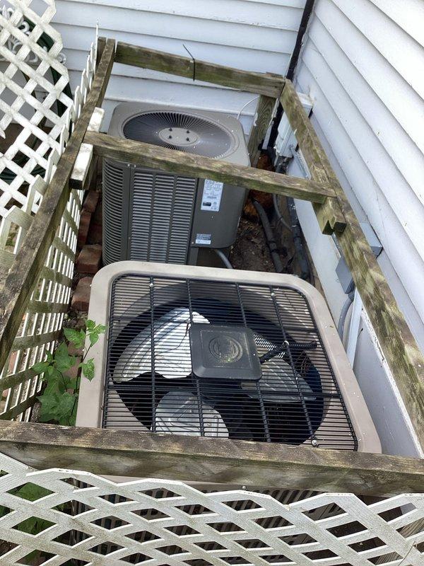 Responded to service call for water leakage from indoor air handler and intermittent power issues affecting dual HVAC system. Upon inspection, found 12-year-old Lennox system with clogged condensate drain line causing water overflow in basement. Cleared blockage from drain line, verified proper drainage flow, and tested condensate pump operation. Inspected outdoor condenser units positioned in exterior enclosure, confirmed both units operational with adequate airflow despite debris accumulation around equipment. Cleaned area around outdoor units and verified electrical connections secure at both indoor and outdoor equipment. Advised customer that intermittent power issues likely result from electrical circuit overload when both systems operate simultaneously during peak cooling demand, recommending evaluation by licensed electrician to assess circuit capacity and potential need for dedicated circuits. System restored to normal operation with proper condensate drainage confirmed.
