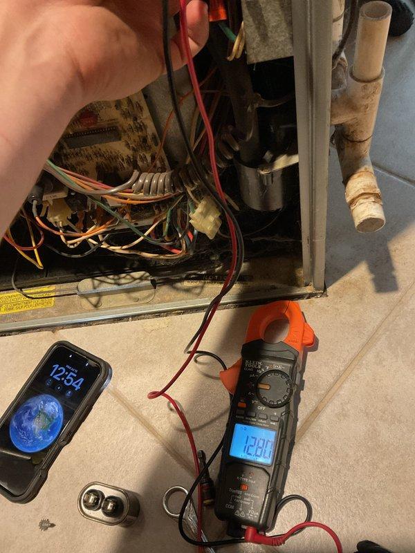Completed HVAC maintenance agreement service on cooling system. Performed diagnostic testing including electrical measurements using clamp meter on internal components, reading 1290 on display. Accessed air handler unit to inspect control board, wiring connections, and internal components. Verified thermostat operation on Honeywell digital unit showing system cooling properly with indoor temperature at 76° and outdoor temperature at 97°. Provided customer with information regarding humidifier installation options for future consideration.