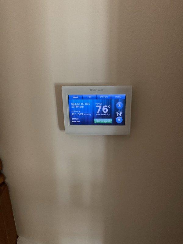 Completed HVAC maintenance agreement service on cooling system. Performed diagnostic testing including electrical measurements using clamp meter on internal components, reading 1290 on display. Accessed air handler unit to inspect control board, wiring connections, and internal components. Verified thermostat operation on Honeywell digital unit showing system cooling properly with indoor temperature at 76° and outdoor temperature at 97°. Provided customer with information regarding humidifier installation options for future consideration.