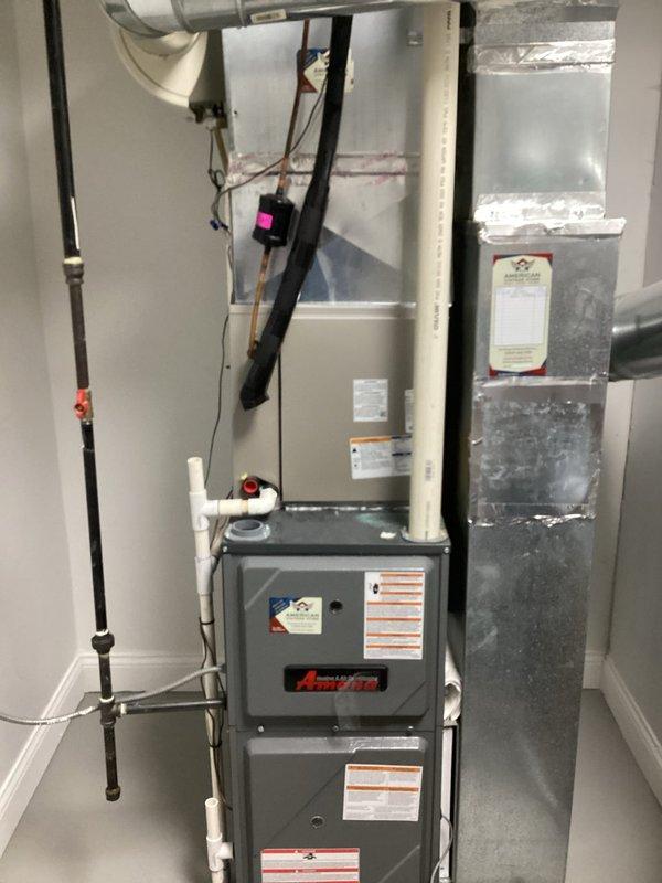 Responded to no cooling complaint on 7-year-old residential air conditioning system affecting entire home. Upon arrival, performed comprehensive system diagnostics using calibrated measurement equipment. Measured air-side temperatures and humidity levels at return and supply plenums. Return air readings showed 88.5°F dry bulb with 49.2% relative humidity, while supply air measured 67.4°F dry bulb with 80.4% relative humidity. Calculated temperature split of 21.1°F across the evaporator coil, confirming adequate system performance and proper refrigerant charge. Inspected indoor air handler and furnace assembly in mechanical room, verifying all electrical connections, condensate drainage system, and gas piping. All components found operating within manufacturer specifications with no deficiencies noted. System cooling properly at time of inspection with appropriate airflow and temperature differential.