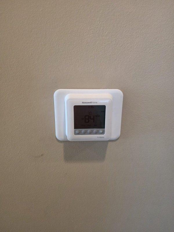 Completed full replacement of two residential HVAC systems, including one unit installed in the attic and one outdoor condenser unit positioned on a concrete pad against the building exterior. The outdoor unit was properly mounted with refrigerant lines and electrical conduit routed along the brick wall, with disconnect box installed for code compliance. New Honeywell Home digital thermostat was installed and programmed to control the system. All equipment was tested for proper operation, refrigerant charge verified, and electrical connections confirmed secure. Job site was left clean and all debris removed.