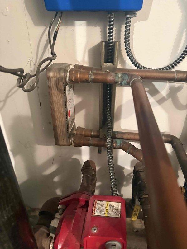 Performed comprehensive diagnostic evaluation on Triangle Tube boiler system experiencing reduced heating efficiency. Inspected hydronic heating components including plate-type heat exchanger, circulation pump, copper piping system, and associated controls. Documented existing conditions showing age-related oxidation on copper joints and fittings, verified proper operation of Tekmar digital thermostat control system currently calling for heat with setpoint at 75°F and ambient temperature at 71°F. Assessed overall system performance and provided estimate for necessary repairs or replacement to restore optimal efficiency.