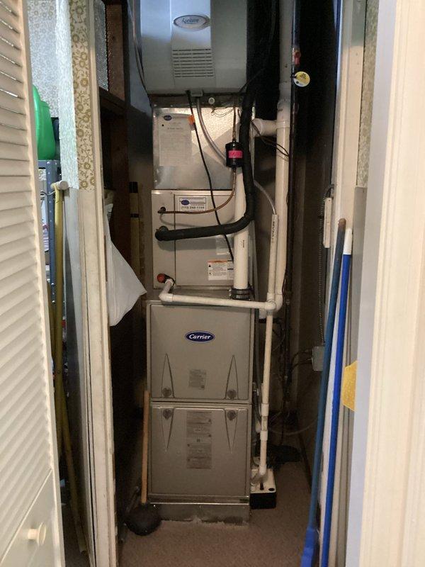 Completed routine HVAC maintenance agreement service on residential Carrier furnace and air conditioning system located in utility closet. Performed comprehensive system inspection, documented equipment condition including capacitor and contactor components, verified proper operation of all mechanical systems, and replaced 16x25x1 air filter to maintain optimal airflow and system efficiency.