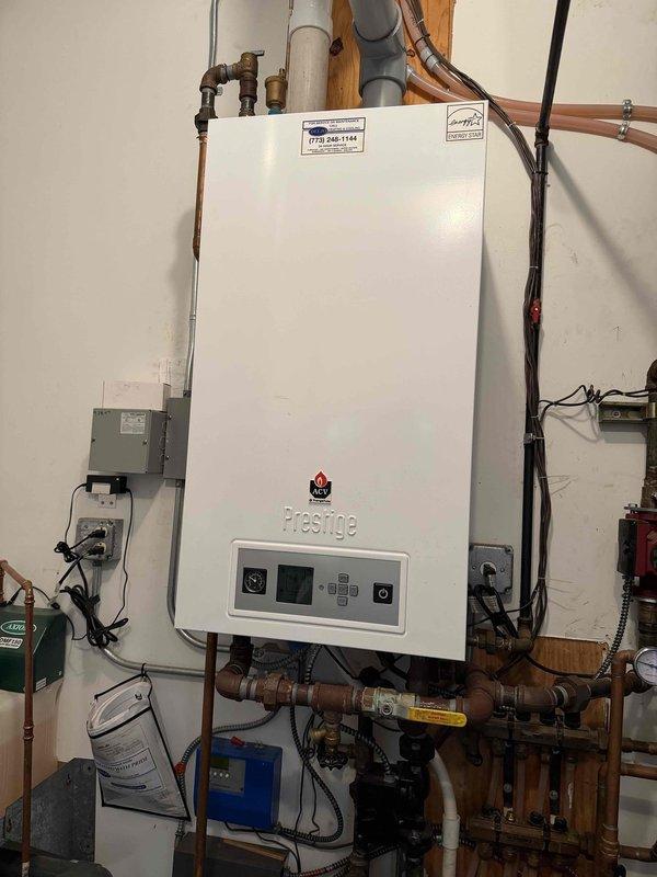 Responded to callback for gas odor at pilot assembly on Prestige tankless water heater. Replaced defective pilot assembly and verified proper combustion with no gas leaks detected. System tested and returned to normal operation with antifreeze protection maintained.