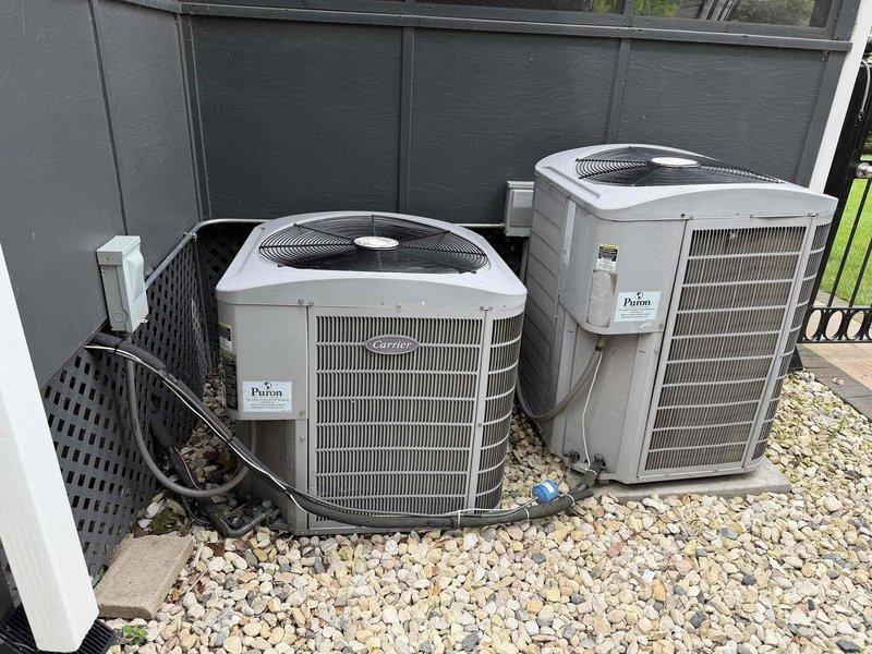 Responded to service call for low voltage electrical issues on dual Carrier air conditioning units. Upon inspection, discovered deteriorated wiring connections and aging control board components within the electrical panel. Performed comprehensive low voltage repairs including replacement of damaged wire segments, re-secured loose connections with new zip ties, and tested all control circuits for proper voltage and continuity. Verified both condensing units were receiving proper 24V control signals from thermostat. All systems tested and operational upon completion.