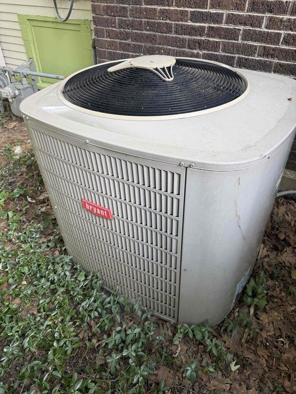Provided comprehensive estimate for complete air conditioning system replacement of twenty-year-old unit. Evaluated existing outdoor condenser unit showing significant age-related wear and assessed attic-mounted air handler with associated ductwork system. Documented current system configuration including exterior condenser placement on concrete pad adjacent to building structure and interior HVAC components installed in attic space with flexible metallic ductwork distribution network.