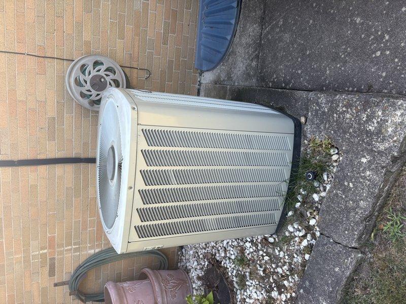 Provided comprehensive estimate for complete air conditioning system replacement. Assessed existing outdoor condenser unit positioned on concrete pad against exterior brick wall, documenting current equipment condition and installation configuration. Presented customer with replacement options and specifications for new HVAC system installation.
