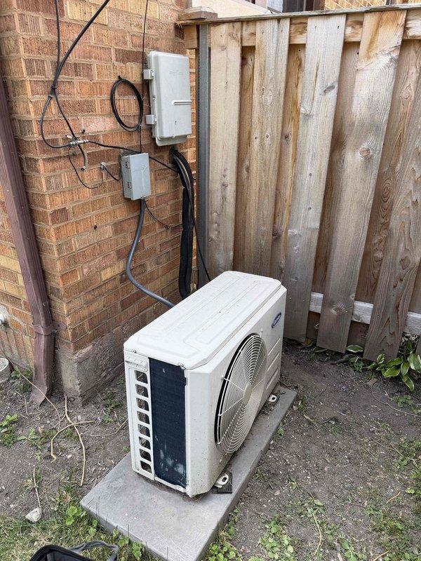 Responded to service call for 10-year-old mini split system with no power condition. Upon arrival, inspected outdoor condensing unit and electrical components mounted on exterior brick wall. Found electrical disconnect switch in OFF position. Verified proper wiring connections at disconnect box, confirmed all conductors were secure and properly terminated. Reset disconnect switch to ON position and restored power to system. Tested unit operation and confirmed condenser fan motor engaged properly and system powered on successfully. Verified electrical connections at outdoor unit were tight and secure. System returned to normal operation with no further issues observed.
