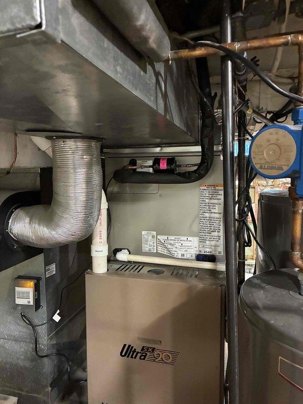 Completed replacement of first-floor air conditioning system and evaporator coil. Installed new indoor coil assembly above existing furnace with proper plenum connections and secured all refrigerant line sets along exterior brick wall to outdoor condensing unit. Verified all electrical connections, tested system operation, and confirmed proper airflow through ductwork.