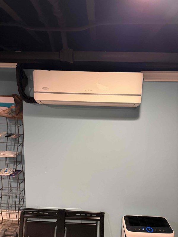 Completed estimate for mini split system replacement. System found with no refrigerant charge and insufficient electrical line length requiring correction. Documented existing wall-mounted indoor unit installation and measured clearances for proper equipment sizing and replacement planning.