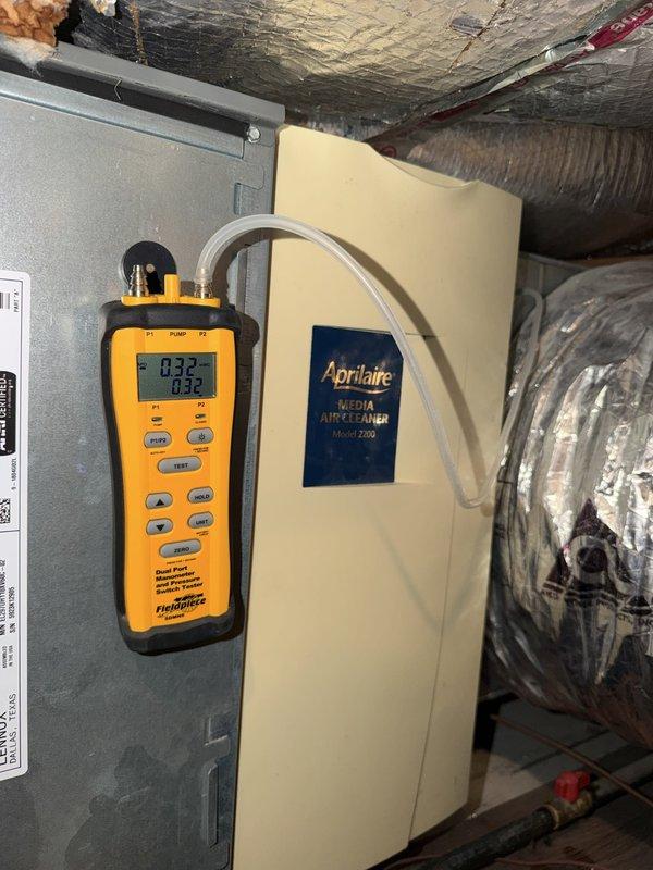 Responded to no cooling complaint with system blowing warm air. Upon inspection, verified airflow through Aprilaire Model 2200 media air cleaner and checked filter condition, which appeared clean and properly installed with correct airflow direction. Performed diagnostic testing using digital manifold gauges, obtaining pressure readings of 32 PSI on both high and low sides, indicating potential refrigerant system issue requiring further evaluation of compressor operation and refrigerant charge levels.