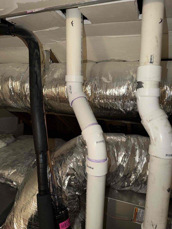 Responded to call back for recently installed air conditioning system reported as non-operational. Upon arrival, performed comprehensive system inspection including attic-mounted ductwork and refrigerant line installations. Inspected foam pipe insulation on refrigerant lines, noting deterioration and potential gaps in coverage that could affect system efficiency. Examined flexible ductwork connections and verified proper sealing at junction points. Checked PVC condensate drain lines for proper pitch and secure connections. Documented existing conditions with photographs showing ductwork configuration, insulation condition, and plumbing installations. System components appeared properly installed with ductwork securely fastened and insulation materials in place, though some insulation showed signs of wear. Verified all mechanical connections in attic space were accessible and properly supported. Rescheduled follow-up appointment to complete diagnostic testing and address any operational