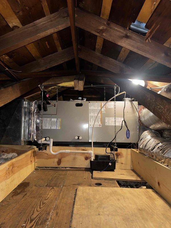 # HVAC System Replacement

Completed full HVAC system replacement including heat pump outdoor unit, air handler, and digital thermostat. New air handler was installed in attic space, properly suspended from structural beams with secure mounting hardware. Unit was connected with appropriate PVC condensate drainage and metallic flex ductwork. Digital programmable thermostat was mounted and configured, displaying system fault code 13-53 indicating control upgrade requirement that will need to be addressed during follow-up service visit.