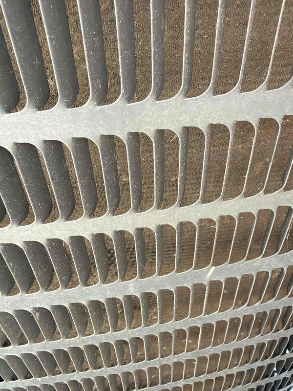Completed comprehensive air conditioning maintenance agreement service on cooling system. Performed thorough inspection of condenser unit including examination of fan motor assembly and condenser coil. Documentation captured showing condenser fan blade configuration and coil fin condition, revealing minor dust accumulation between coil fins that was addressed during routine cleaning procedures to maintain optimal heat transfer efficiency and system performance.
