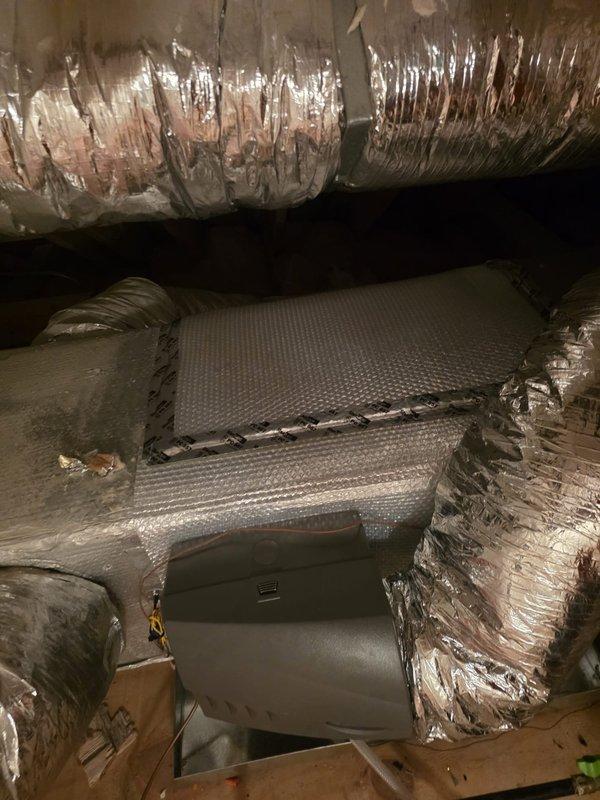 Responded to callback for plenum insulation near humidifier installation. Upon arrival, accessed attic space and located HVAC air handler and associated ductwork. Applied proper insulation to exposed plenum section adjacent to humidifier connection point to prevent condensation issues and improve system efficiency. Verified all ductwork connections remained secure and properly sealed. Documented completed work with photographs showing insulated plenum and surrounding HVAC components.