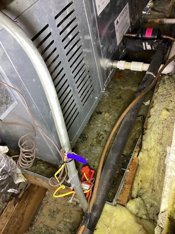 Responded to service call for leak from air conditioning unit. Upon arrival, found evidence of refrigerant leak at indoor evaporator coil connections with oil residue present. Performed leak detection using electronic leak detector and identified active leak at brazed joint near filter drier. Recovered remaining refrigerant from system, repaired leak through proper brazing techniques, pressure tested system to 350 PSI with nitrogen to verify integrity of repair, evacuated system to 500 microns, and recharged unit to manufacturer specifications. Verified proper system operation with temperature split of 18 degrees across evaporator coil and confirmed all pressures within normal operating range. Cleaned condensate drain line which showed signs of biological growth and recommended improved maintenance schedule to prevent future issues. Outdoor condenser unit operating normally with proper airflow, though vegetation encroachment noted and customer advised to maintain clearance for optimal 
