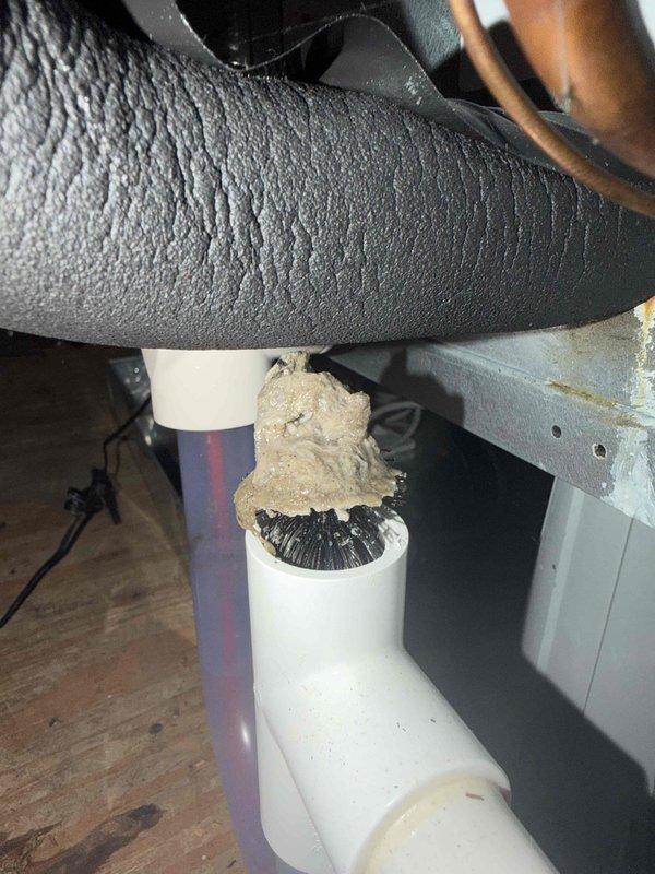 Responded to no cooling complaint for upstairs zone. Upon inspection, discovered condensate drain line blockage causing safety float switch activation, which shut down the air handler. Recovered refrigerant from system, cleared the clogged drain line, verified proper drainage flow, and tested float switch operation. Recharged system to manufacturer specifications, confirmed airflow restoration, and verified cooling operation resumed normally to upstairs areas.