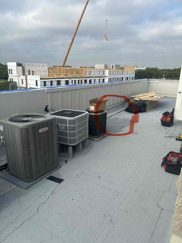 Provided remote quote for rooftop HVAC equipment replacement on commercial building. Assessed existing Lennox condenser units positioned on flat membrane roofing surface and documented current installation conditions including equipment placement, mounting pads, and rooftop access considerations for replacement work.