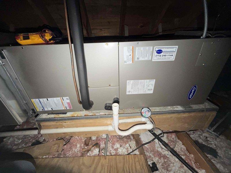 Responded to emergency no cooling call on Carrier air handler system located in attic space. Upon arrival, connected manifold gauges to assess refrigerant pressures and system operation. Diagnosed system issue and performed necessary service to restore cooling function.