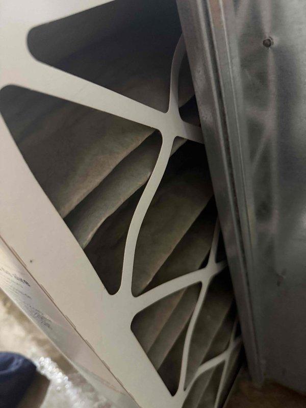 Completed comprehensive HVAC maintenance agreement service including air conditioning system and water heater inspection. Verified air filter condition and accessibility, documented clean pleated filter media in return air housing, and inspected ductwork components and water heater combustion chamber opening with gasket seal intact and operational.