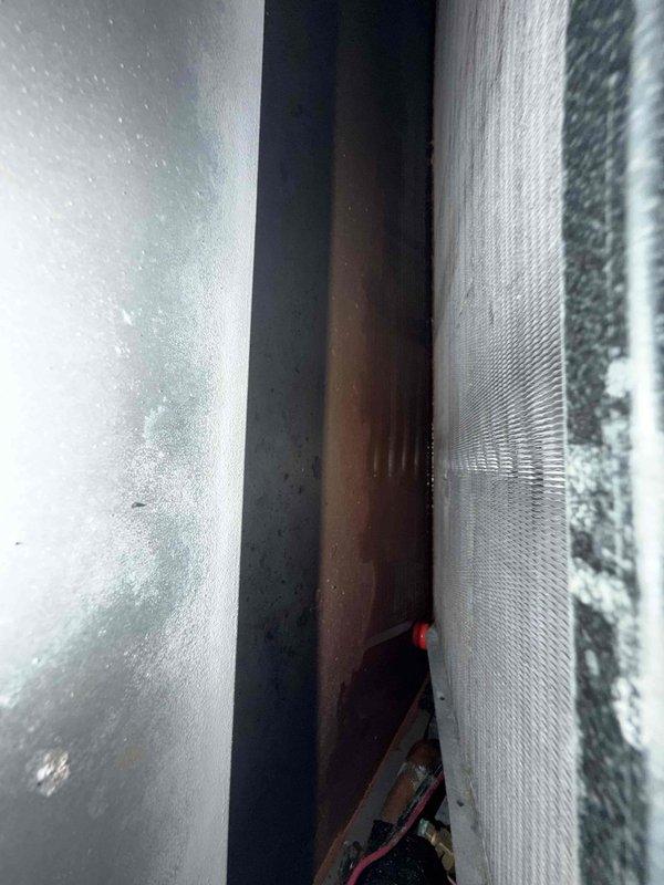 Completed comprehensive cooling maintenance on three air conditioning systems and three Unico small-duct high-velocity blowers as part of routine maintenance agreement. Replaced air filters throughout the property using specified sizes: 16x25x1, 14x20x1, and 12x30x1 filters for the guest suite second floor unit. Inspected evaporator coils and found normal condensation on metal ductwork assembly indicating proper system operation and temperature differential. Examined refrigerant lines, ductwork connections, and air handler components in confined installation spaces. All systems operating within normal parameters with no deficiencies noted.