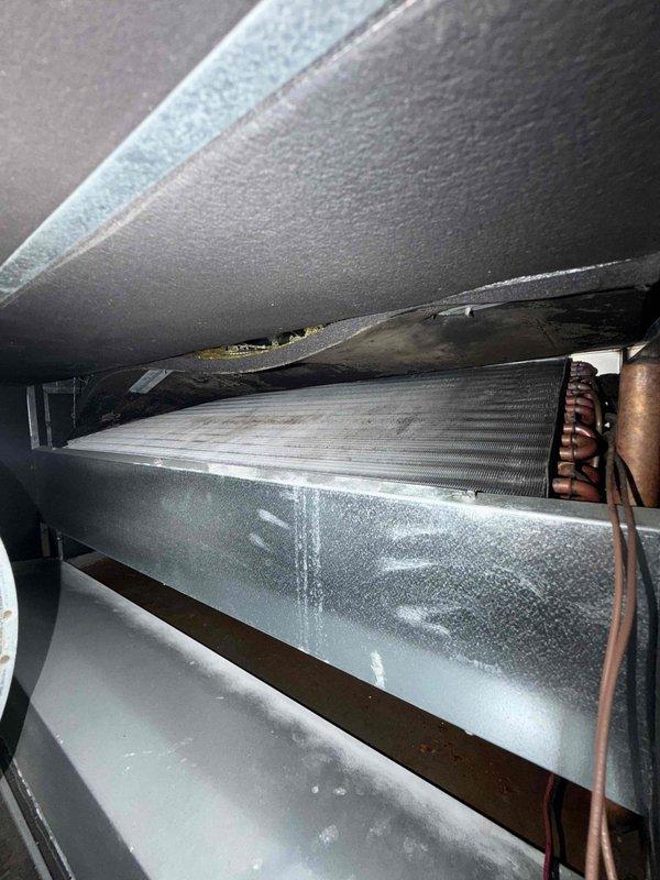 Completed comprehensive cooling maintenance on three air conditioning systems and three Unico small-duct high-velocity blowers as part of routine maintenance agreement. Replaced air filters throughout the property using specified sizes: 16x25x1, 14x20x1, and 12x30x1 filters for the guest suite second floor unit. Inspected evaporator coils and found normal condensation on metal ductwork assembly indicating proper system operation and temperature differential. Examined refrigerant lines, ductwork connections, and air handler components in confined installation spaces. All systems operating within normal parameters with no deficiencies noted.