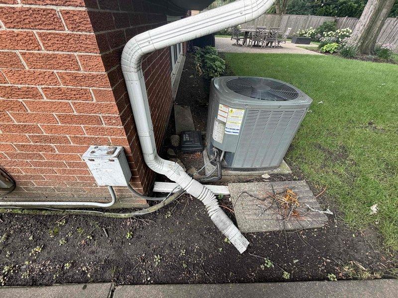 Completed routine HVAC maintenance agreement service on residential air conditioning system. Performed comprehensive inspection of outdoor condenser unit and indoor components, including filter replacement with 16x25x1 media filter. Verified proper operation of all system components, checked refrigerant levels, inspected electrical connections at disconnect box, and evaluated condensate drainage system. Documented equipment condition with photographic records showing exterior condenser unit installation and interior mechanical room components for maintenance history files.
