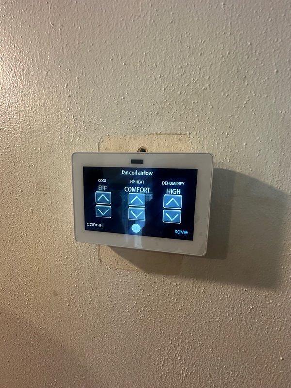 Responded to system fault high humidity alert on recently installed thermostat. Accessed fan coil airflow settings and adjusted dehumidify parameters from high to comfort mode. Verified supply air temperature at air handler reading 55°F, confirming proper system operation and resolving the false humidity warning.