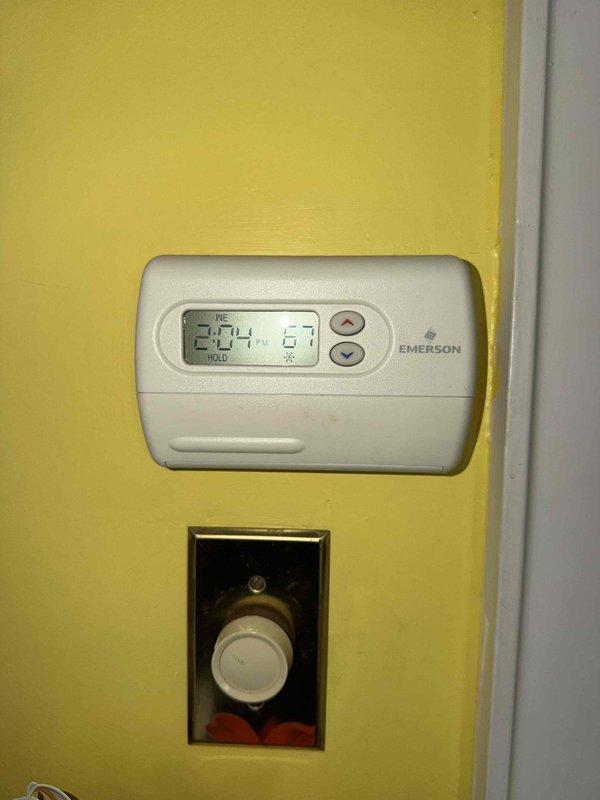 Completed spring cooling tune-up on residential air conditioning system. Performed comprehensive inspection of condenser unit, verified thermostat operation showing 74°F set point in hold mode, and documented severe frost accumulation on evaporator coil with surface temperature reading of 62.6°F. The extensive ice buildup on the coil indicates potential airflow restriction, refrigerant charge issue, or system operating continuously below design parameters that will require further diagnosis and correction to restore proper cooling performance.