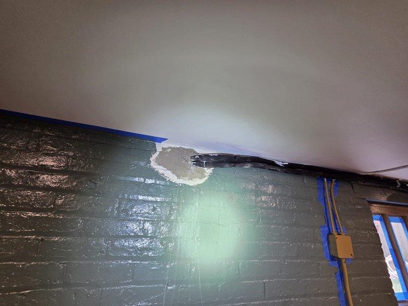 Responded to warranty claim for failed penetration sealant from previous mini-split installation. Upon arrival, confirmed that patching material used at lineset wall penetrations had melted and dripped down both interior and exterior walls. Pressure washed and cleaned affected wall surfaces to remove residual material. Removed deteriorated sealant from penetration points and properly resealed all lineset wall penetrations using appropriate exterior-grade cement compound rated for HVAC applications. Verified proper seal integrity at all penetration locations and confirmed no further material degradation or dripping present.