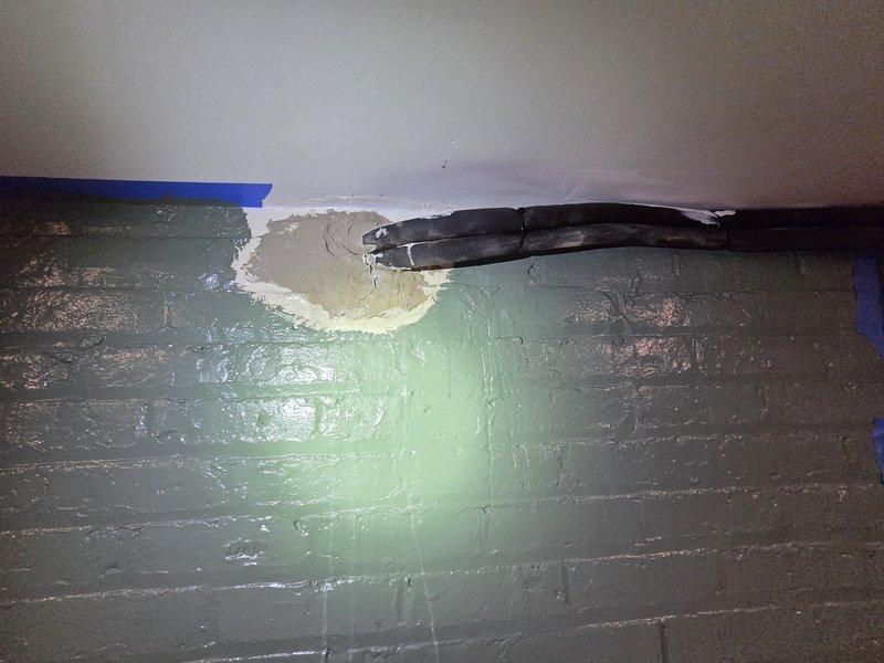 Responded to warranty claim for failed penetration sealant from previous mini-split installation. Upon arrival, confirmed that patching material used at lineset wall penetrations had melted and dripped down both interior and exterior walls. Pressure washed and cleaned affected wall surfaces to remove residual material. Removed deteriorated sealant from penetration points and properly resealed all lineset wall penetrations using appropriate exterior-grade cement compound rated for HVAC applications. Verified proper seal integrity at all penetration locations and confirmed no further material degradation or dripping present.