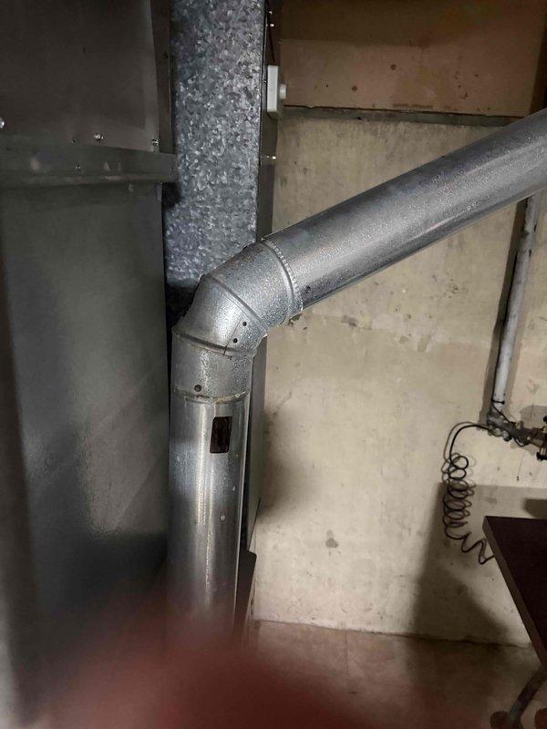 Conducted on-site evaluation for complete HVAC system replacement including air conditioning unit and furnace, both approximately 15 years old and nearing end of service life. Performed comprehensive assessment of existing ductwork system, measuring supply and return trunk lines to verify compatibility with proposed replacement equipment. Documented current system configuration including metal ductwork routing, elbow joints, and connection points in mechanical space. Evaluated outdoor equipment accessibility, confirming ground-level placement requiring no ladder work for installation access. Captured detailed measurements and photographic documentation of existing ductwork dimensions, seam construction, and mounting locations to ensure accurate equipment sizing and proper integration with current distribution system. Assessed mechanical room layout and clearance requirements for new equipment installation. Provided customer with replacement options and technical specifications based on