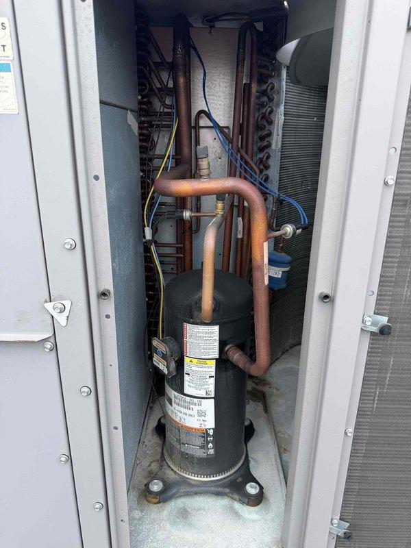 Performed commercial preventive maintenance agreement service on rooftop unit requiring 15-20' ladder access. Completed inspection of RTU cooling system components including compressor, refrigerant lines, and condenser coils. Installed pleated filters per special customer request specifications. Documented equipment condition with temperature readings and visual inspection of internal components showing moderate dust accumulation on ductwork and surfaces. Verified compressor operation, checked refrigerant line connections, and inspected copper coil assemblies and condenser fins. Unit operating within normal parameters upon completion of maintenance service.