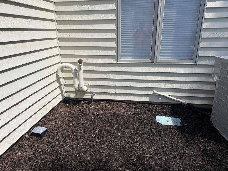 Responded to service call for sump pump running continuously for 48 hours. Upon arrival, conducted thorough inspection of sump pump system and associated discharge plumbing in crawlspace and exterior areas. Examined PVC discharge piping configuration, including vertical and horizontal runs with multiple joints and elbows throughout the utility space. Inspected exterior discharge point with cleanout access near foundation. Evaluated pump operation cycle, float switch mechanism, and check valve function. Documented system layout and current conditions via photographs for service records.