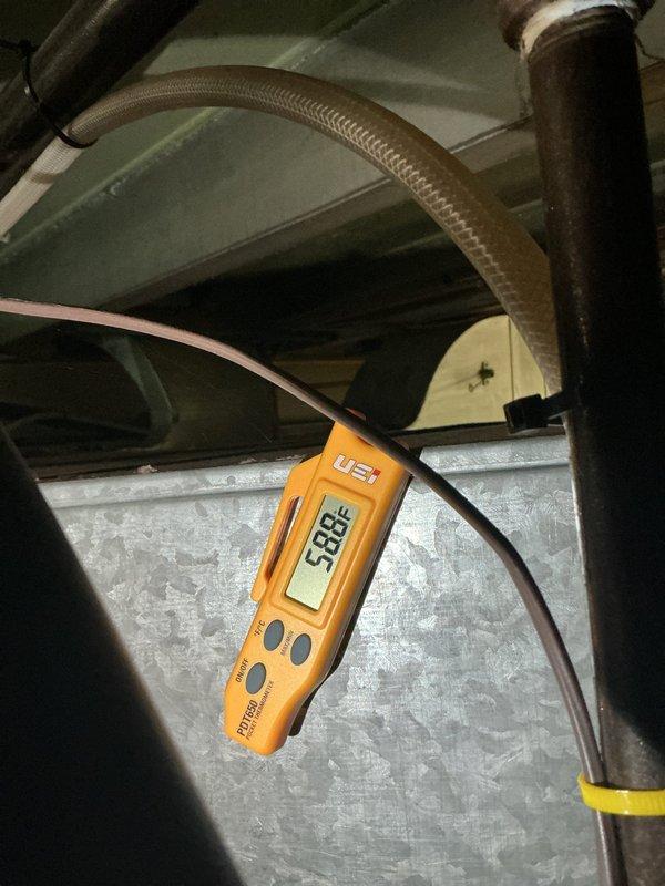 Responded to service call regarding main floor thermostat not maintaining temperature. Performed diagnostic inspection of HVAC system in attic space, including temperature measurements of supply ductwork which registered 53.8°F at the plenum. Inspected duct board construction, insulation integrity, and system components to identify cause of inadequate heating performance. Contacted homeowner via phone and text message with findings and diagnosis as requested.