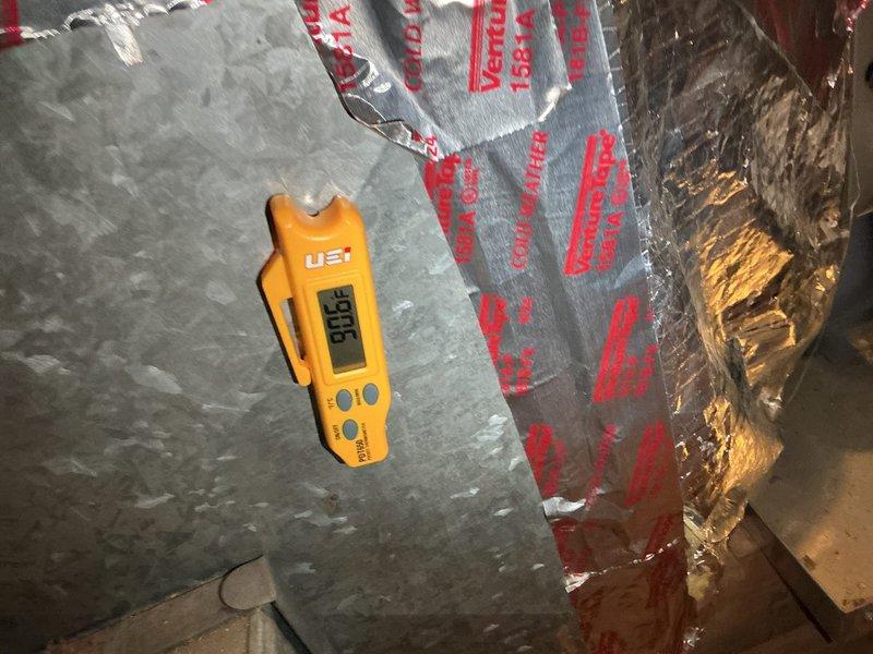 Responded to service call regarding main floor thermostat not maintaining temperature. Performed diagnostic inspection of HVAC system in attic space, including temperature measurements of supply ductwork which registered 53.8°F at the plenum. Inspected duct board construction, insulation integrity, and system components to identify cause of inadequate heating performance. Contacted homeowner via phone and text message with findings and diagnosis as requested.