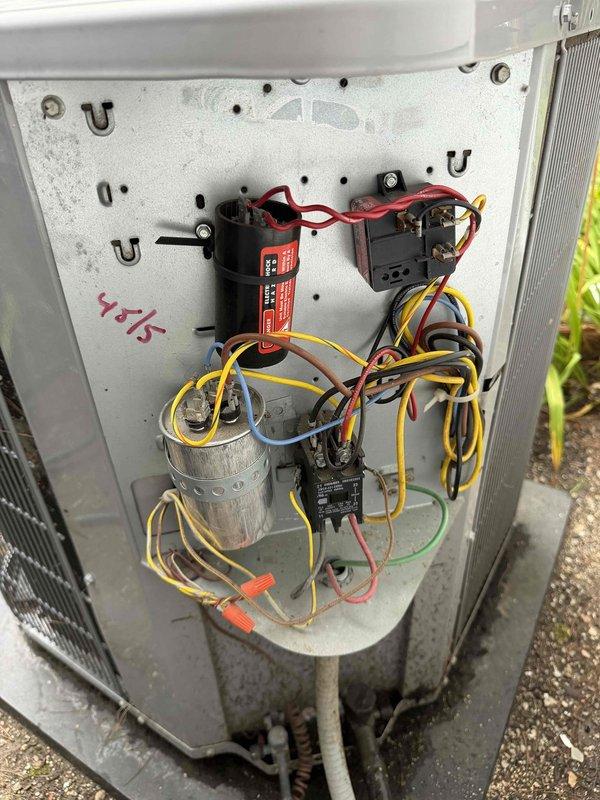 Completed comprehensive maintenance agreement service on two condenser units. Inspected electrical compartments revealing aged capacitor and multiple contactors with proper wiring connections intact. Observed significant debris accumulation on condenser coils requiring attention. Documented equipment condition showing weathering consistent with extended service life, including 4x15 marking on electrical panel. Both units assessed and photographed for maintenance records.