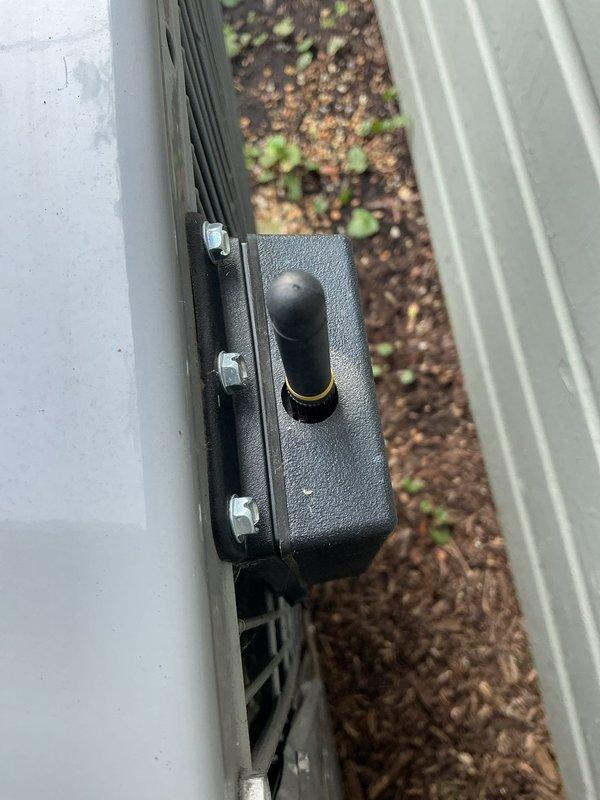 Returned to complete installation of wireless transceiver in condenser unit electrical compartment. Secured transceiver with mounting hardware and applied caulk bead around installation point to seal and weatherproof the connection.