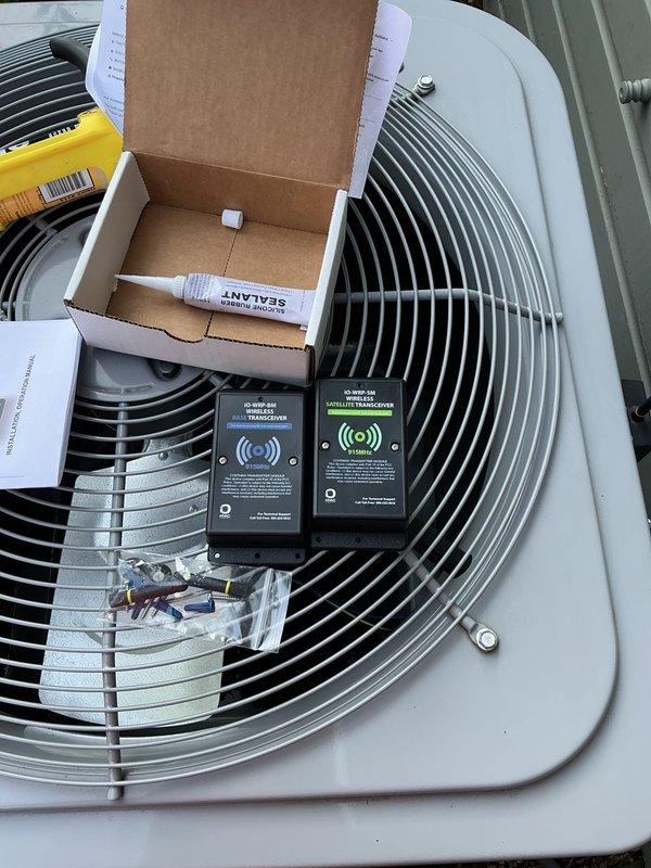 Returned to complete installation of wireless transceiver in condenser unit electrical compartment. Secured transceiver with mounting hardware and applied caulk bead around installation point to seal and weatherproof the connection.